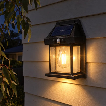Solar wall light glowing on an outdoor wall at night