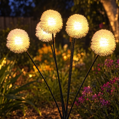 HiLuci Dandelion Lights glowing above a garden bed at night