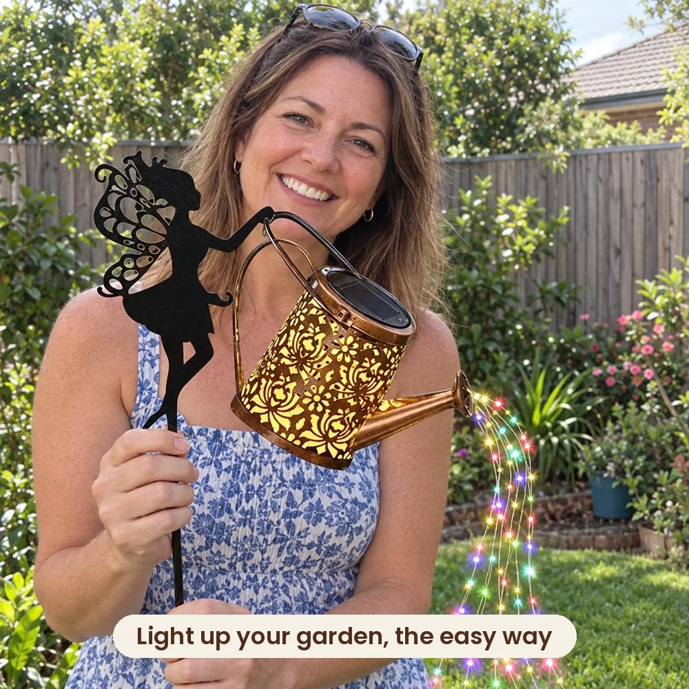 Woman holding the HiLuci Fairy Watering Can solar light in her garden